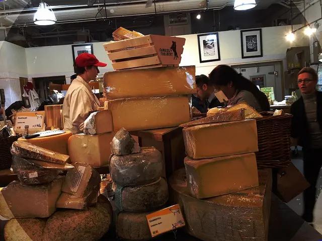 A specialty cheese shop counter with wheels and wedges of cheese on display at the Ferry Building in San Francisco.