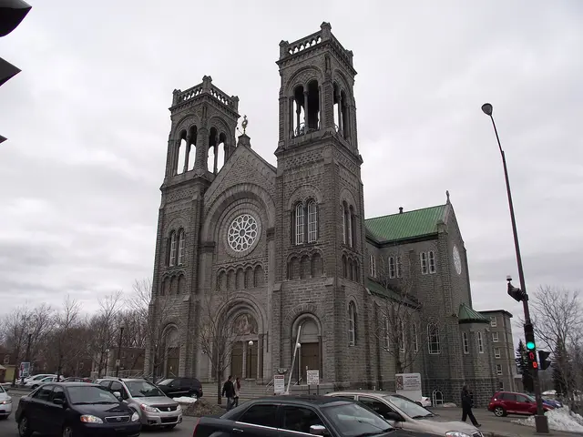 A grey stone Catholic church with twin bell towers and a large rose window, Église de la Paroisse Très-Saint-Sacrement in Quebec City