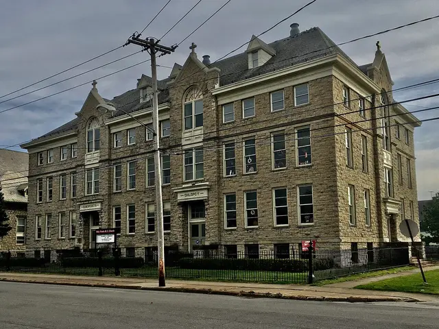 The stone facade of the former Holy Trinity Catholic School building in Niagara Falls, New York.