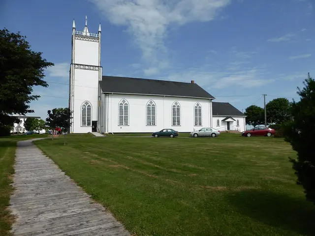 St. Augustine's Roman Catholic Church on Prince Edward Island, a light stone Catholic church exterior with round-arched stained glass windows.